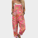 Dorka | Rožinė jumpsuit su tropiniais gėlėmis